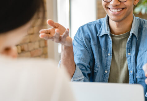 A student being interviewed, seated across from an interviewer