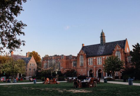 View of Ivy League campus with gothic architecture, under string lights during early evening