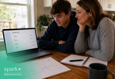 Parent and student reviewing college applications on a laptop at home.